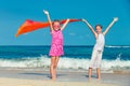 Two sisters standing on the beach and pulled up his hands Royalty Free Stock Photo