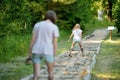 Two sisters on tactile path in barefoot park created to feel the ground and other materials with bare feet. Strengthen foot and