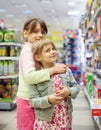 Two sisters in toy store Royalty Free Stock Photo