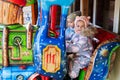 Two sisters in train carousel in amusement park Royalty Free Stock Photo