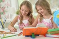 Two sisters twins doing homework Royalty Free Stock Photo