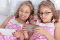 Two sisters twins using smart phones Royalty Free Stock Photo