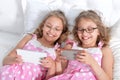 Two sisters twins using smartphones