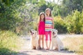 Two sisters on a walk with the dogs in the park Royalty Free Stock Photo