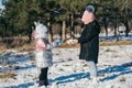 Two sisters of different ages on a winter walk in a snowy park Royalty Free Stock Photo