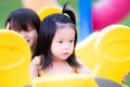 Two sisters were playing climbing and hiding behind playground equipment. Two girls are playing hide and seek with their friends. Royalty Free Stock Photo