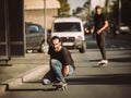 Two skateboarders ride a skateboard slope in the city street Royalty Free Stock Photo