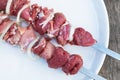 Two skewers with raw lamb with onion on dish on old wooden table, top view. Skewers with meat for grill Royalty Free Stock Photo