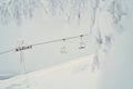 Two ski lifts or chairlifts pictured through the snow-covered trees. Empty chairlifts going up the slope, no people. Beautiful Royalty Free Stock Photo