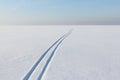Two ski tracks leaving afar on a snow field Royalty Free Stock Photo