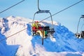 Two skiers lifting on lift against snowy mountains Royalty Free Stock Photo