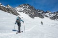 Two skiers skinning up slope near Snowbird Mine in Hatcher Pass area in the Talkeetna Mountains, Alaska