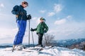 Two skiers on the top of snow hill ready to slow down