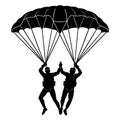 Two skydivers giving high five under parachute Royalty Free Stock Photo