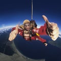 Two skydivers giving thumbs-up in mid-air portrait