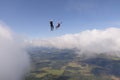 Skydiving. Freefly jump above white clouds. Royalty Free Stock Photo