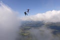 Skydiving. Freefly jump above white clouds. Royalty Free Stock Photo