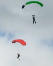 Two skydivers performing skydiving with parachutes