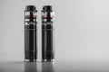 Two Sleek Black Vapes Rest on a Pristine White Surface, Ready to Elevate the Vaping Experience Royalty Free Stock Photo
