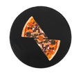 Two slice of delicious pizza with cherry tomatoes, spinach, mozzarella, feta, kalamata olive and mushrooms on slate round plate Royalty Free Stock Photo