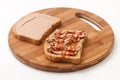 Two slices of bread coated with pate and ketchup on wooden board Royalty Free Stock Photo