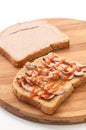 Two slices of bread coated with pate and ketchup on wooden board Royalty Free Stock Photo