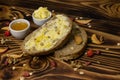 Two slices of bread and a cup of honey and butter and decorated with pieces of dried apple lying on a wooden background Royalty Free Stock Photo