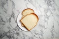 Top view Two slices of bread on white plate on marble background Royalty Free Stock Photo