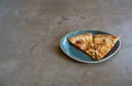 Two slices of delicious pizza on a designer loft-style porcelain plate