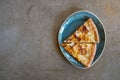 Two slices of delicious pizza on a designer loft-style porcelain plate. View from above