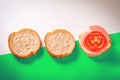 Two Slices of Fresh Bread with Sesame Seeds in Crust, One Open Sandwich with Slices of Cheese, Cooked Sausage and Tomato on Top. Royalty Free Stock Photo