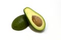 Two slices of fresh organic avocado isolated on a white background. One slice with core. Design element for product