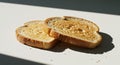 Two slices of golden brown toast bathed in sunlight, casting sharp shadows Royalty Free Stock Photo