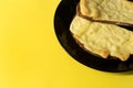 Two slices of grilled cheese on toast on black plate and bright Royalty Free Stock Photo