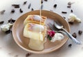 Two slices of Japanese style cheesecake, soft souffle served on a plate with a toping.