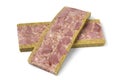 Two slices of traditional Belgian brawn, head cheese, with mustard on white background