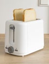 Two slices of white bread ready for toasting in an electrical toaster Royalty Free Stock Photo