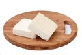 Two slices of white feta cheese on a kitchen board Royalty Free Stock Photo