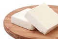 Two slices of white feta cheese on a kitchen board Royalty Free Stock Photo