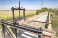 Sluicegates on a dry irrigation watercourse canal and a field of corn Royalty Free Stock Photo