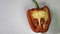 Two small bell peppers growing inside a red one, silver glitter backdrop. Negative space. Copy space for advertising