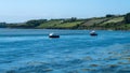 Two small boats are anchored in Clonakilty Bay on a spring day. Beautiful Irish seaside landscape. Clear sky and blue water, boats Royalty Free Stock Photo