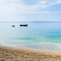 Two small boats in calm water near the sandy shore Royalty Free Stock Photo