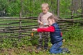 Two small boys lighting a fire in woodland Royalty Free Stock Photo