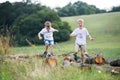 Two small boys running in nature on a summer day.