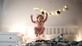 Two small children jumping on bed indoors at home, having fun. Royalty Free Stock Photo