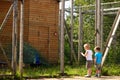 Two small children look at a peacock in a zoo