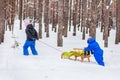 Two small children with sleds in the forest. Family walk in the woods