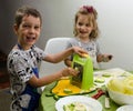 Two small children preparing a meal