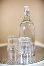 Two small drinking glasses and an empty water bottle Royalty Free Stock Photo